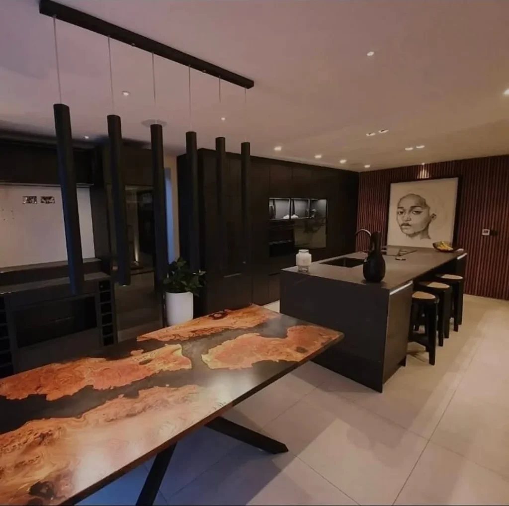 https://fixandflipconstruction.co.uk/wp-content/uploads/2026/08/bespoke-live-edge-dining-table-dark-kitchen-wide-1024x1018.webp
