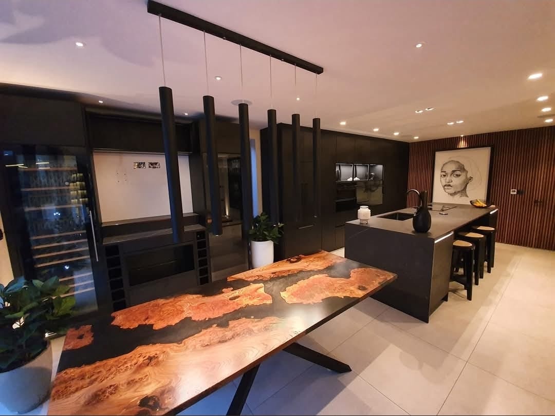 https://fixandflipconstruction.co.uk/wp-content/uploads/2026/08/bespoke-live-edge-dining-table-dark-kitchen.jpg