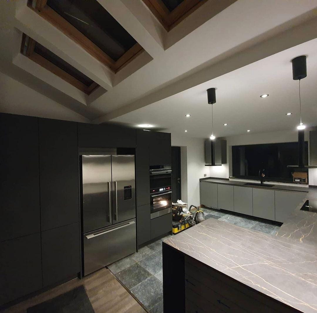 https://fixandflipconstruction.co.uk/wp-content/uploads/2026/08/charcoal-kitchen-night-stainless-fridge-freezer.jpg