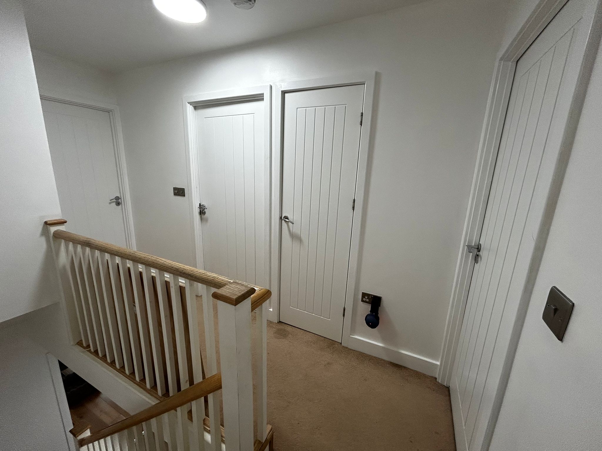 https://fixandflipconstruction.co.uk/wp-content/uploads/2026/08/upstairs-landing-white-doors-staircase.jpg