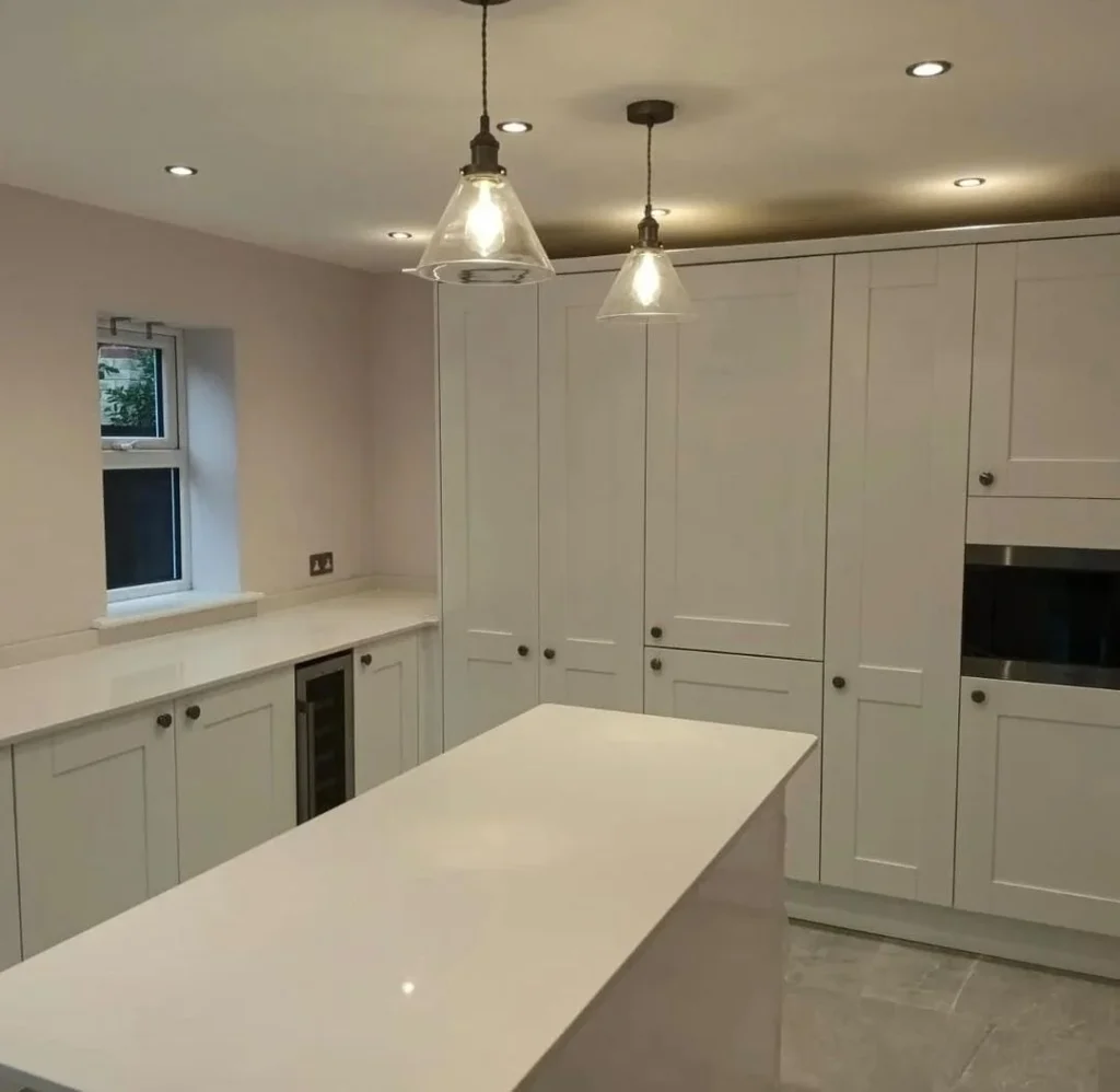 https://fixandflipconstruction.co.uk/wp-content/uploads/2026/08/white-shaker-kitchen-island-pendant-lighting-1024x998.webp